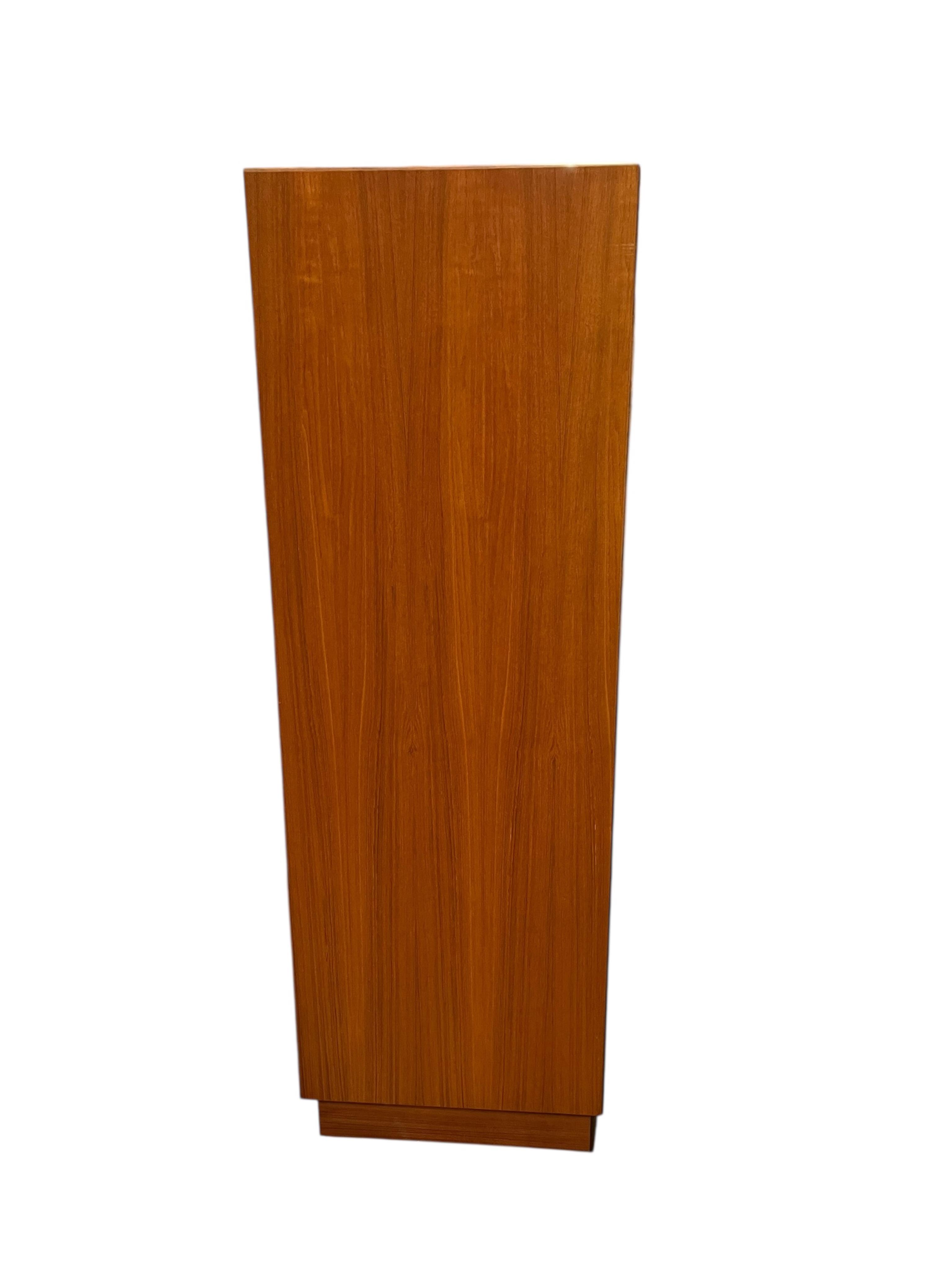 A mid century G Plan Fresco teak bedroom suite comprising a three door wardrobe, a two door wardrobe, two six drawer chests, dressing table, headboard and a pair of bedside chests